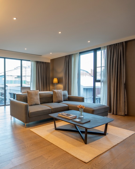 Two-bedroom suite living room separate areas Walton Suites Bangkok